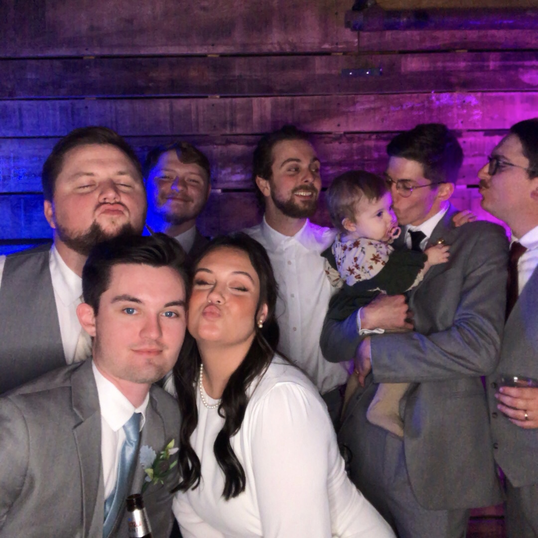 Open-air photo booth rental — group of friends posing with props